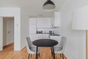 Cozy living space with a round dining table and integrated kitchen area.