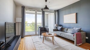 A modern living room with a sofa, coffee table, and TV.