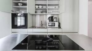 A modern kitchen with a built-in oven, microwave, and a sink. - Gorgeous Horgen 3BR, 2 min to Train Station, by Blueground (Zurich)