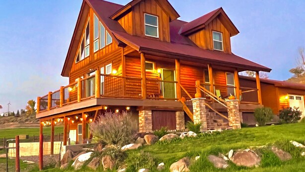 A large, two-story wooden house with a prominent porch and multiple windows. - Montrose Quiet Country Home with a View on 3 Acres! (Montrose)