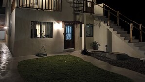 A two-story house with a balcony, a staircase, and a well-lit entrance. - Explore this spacious 3-bedroom apartment with WiFi, AC in nice Perula (Perula)