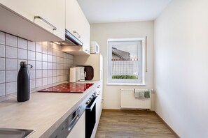 A compact kitchen with a microwave, kettle, and kettle on the counter. - Apartment 'Ferienwohnung Typ 1' with Mountain View, Shared Terrace and Wi-Fi (Willingen (Upland))
