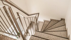 A staircase with metal railings and granite steps.