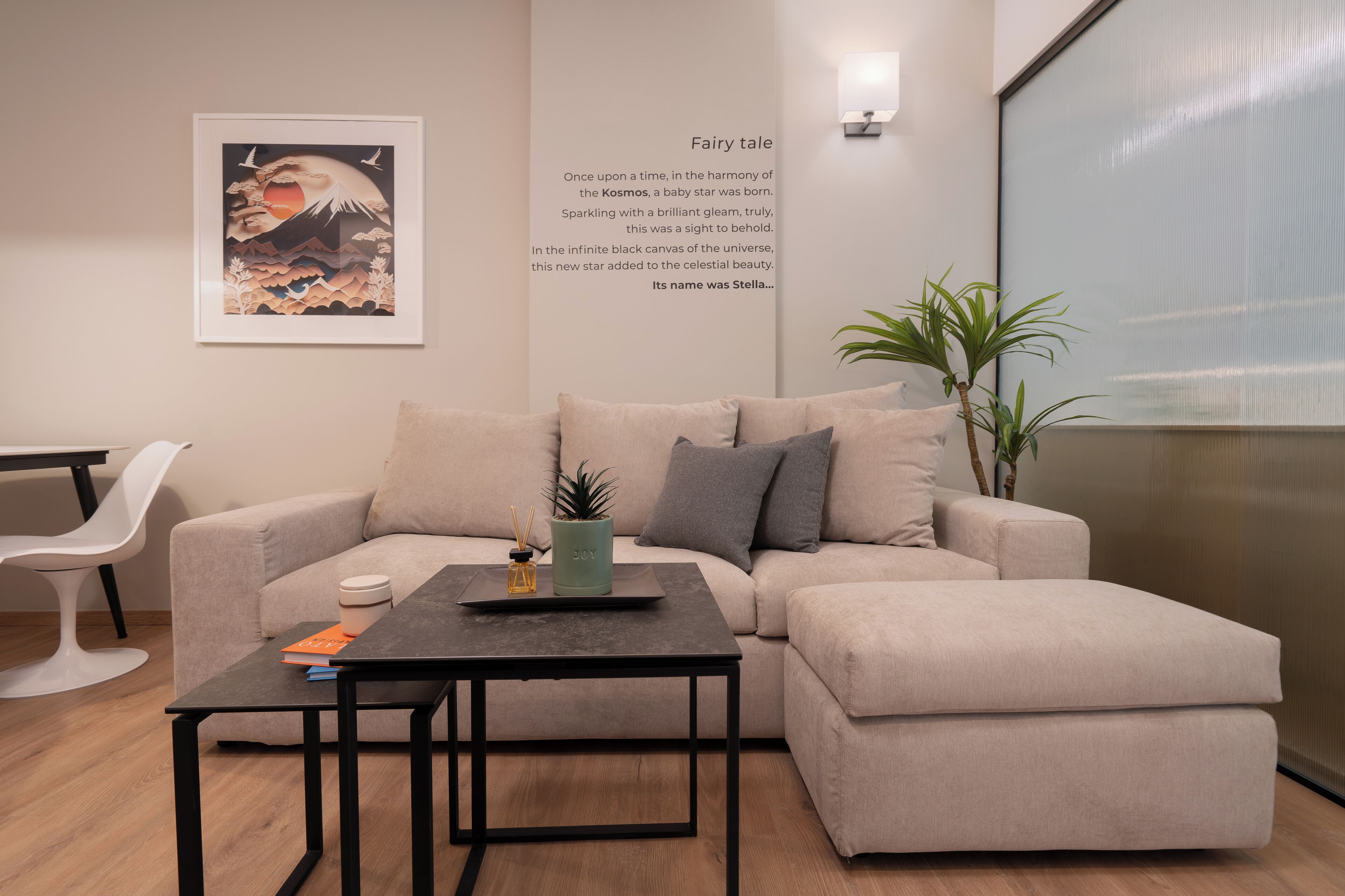A modern living room with a sofa, a coffee table, and a wall-mounted artwork.