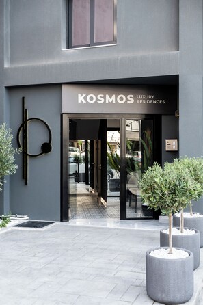 A modern building with a sign reading "KOSMOS LUXURY RESIDENCES". - Kosmos Luxury Residences (Athens)