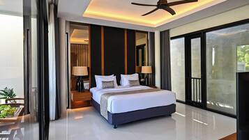 A modern hotel room with a large bed, a ceiling fan, and a view through the glass door.
