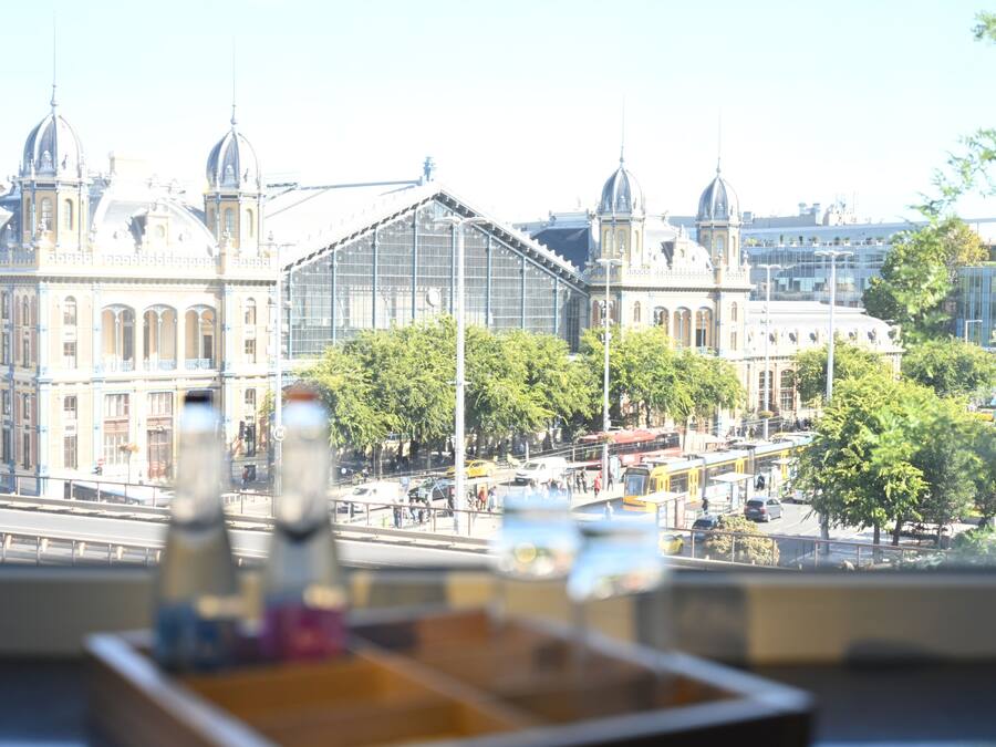 A view of a cityscape with historic buildings and a modern glass structure.