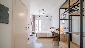 A modern bedroom with a bed, desk, and wardrobe. - Ciuri' affittacamere (Alcamo)