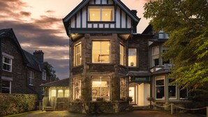A traditional stone building with a gabled roof and multiple windows, likely a hotel or inn, with a sign indicating it is 'The Rosemount'.