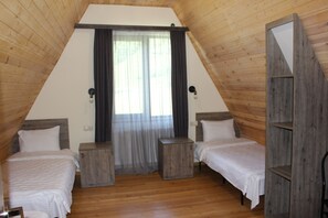 A room with two beds, wooden walls, a window with curtains, and a wooden shelf. - Hotel TWINS Achkhoti (Kazbegi)
