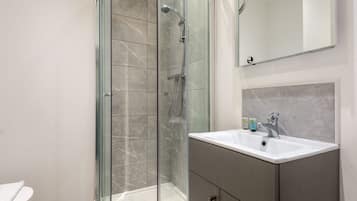 Shower, hair dryer, towels, shampoo