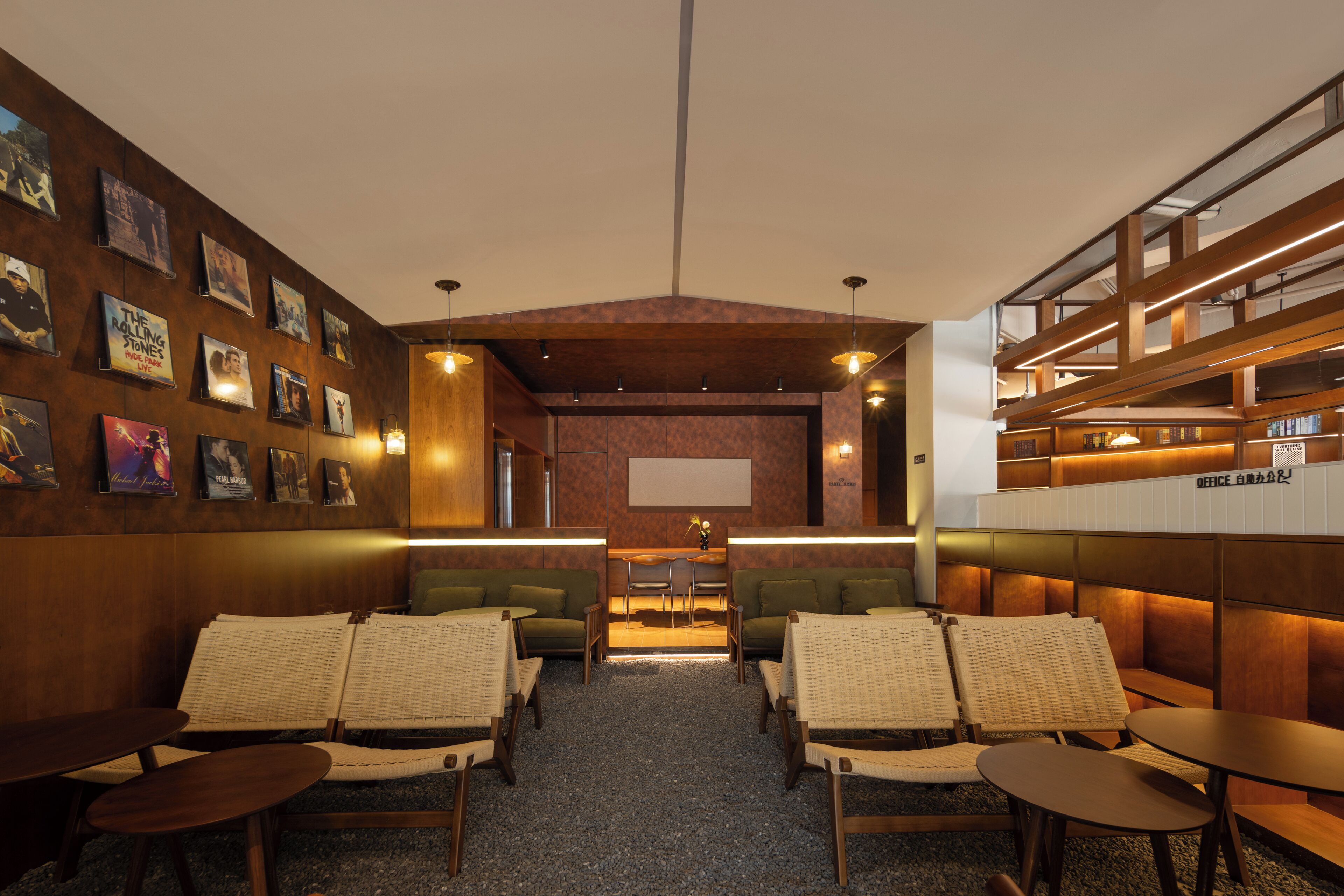 A cozy lounge area with seating, a coffee bar, and a wall adorned with framed pictures.