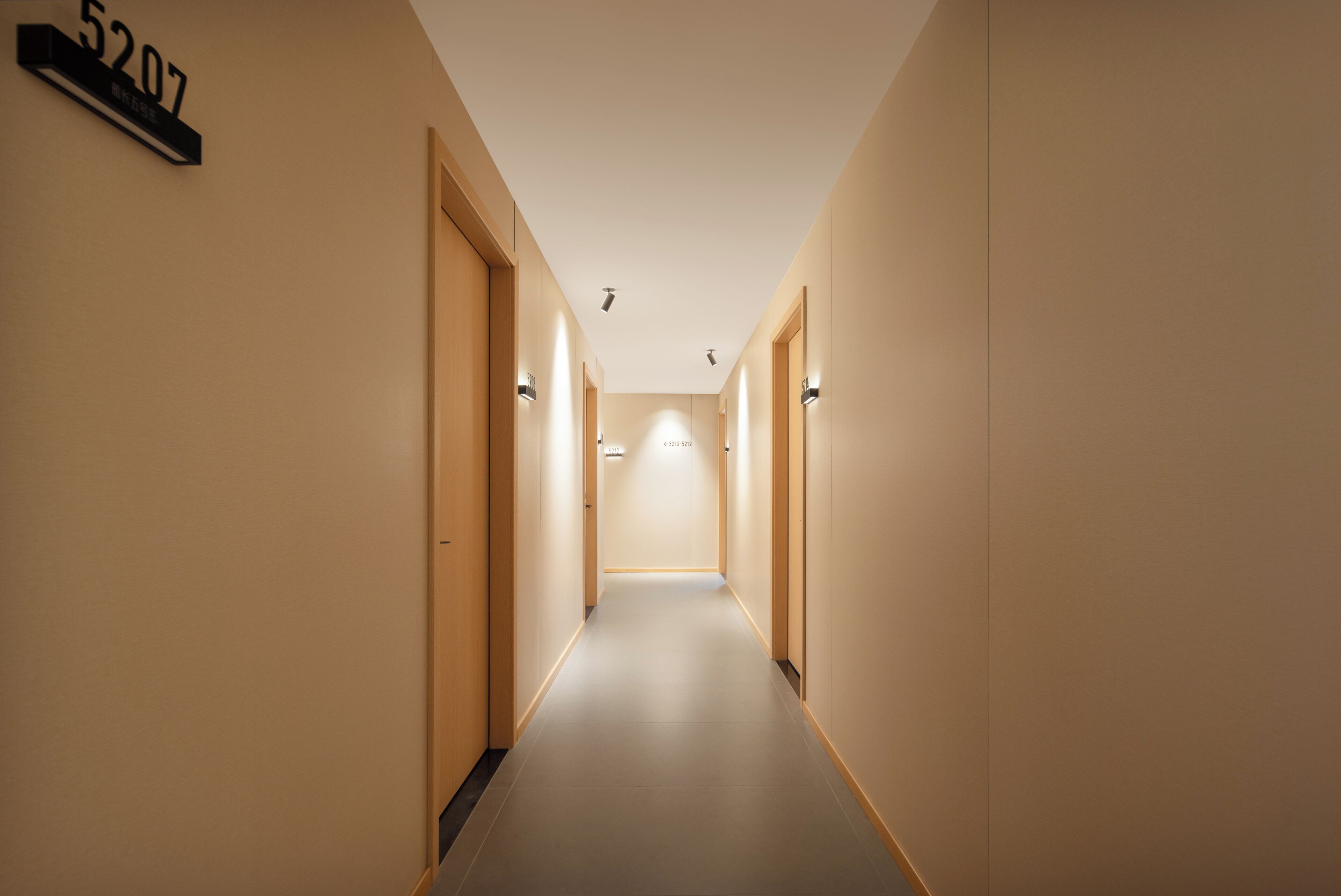 A long, narrow hallway with a number sign indicating room 5207.