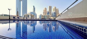 Outdoor pool, open 10:00 AM to 6:00 PM, pool umbrellas, sun loungers - WOW Studio w Balcony and Canal View  (Dubai)