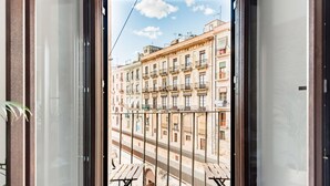 A view from a balcony with a metal railing, overlooking a street with multi-story buildings. - Unik Vacation Circus (Tarragona)