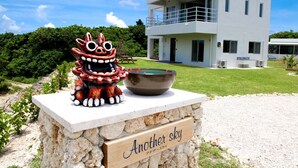 A modern building with a stone base and a sign reading "Another sky".