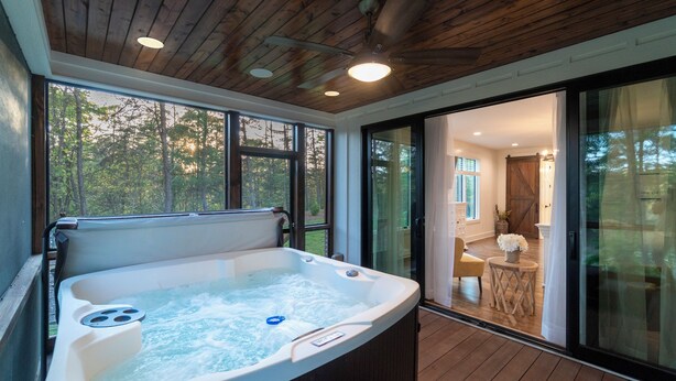 A hot tub with a wooden ceiling and large windows. - Comfy Bear Mountain Lodge| Family-Friendly (Helen)