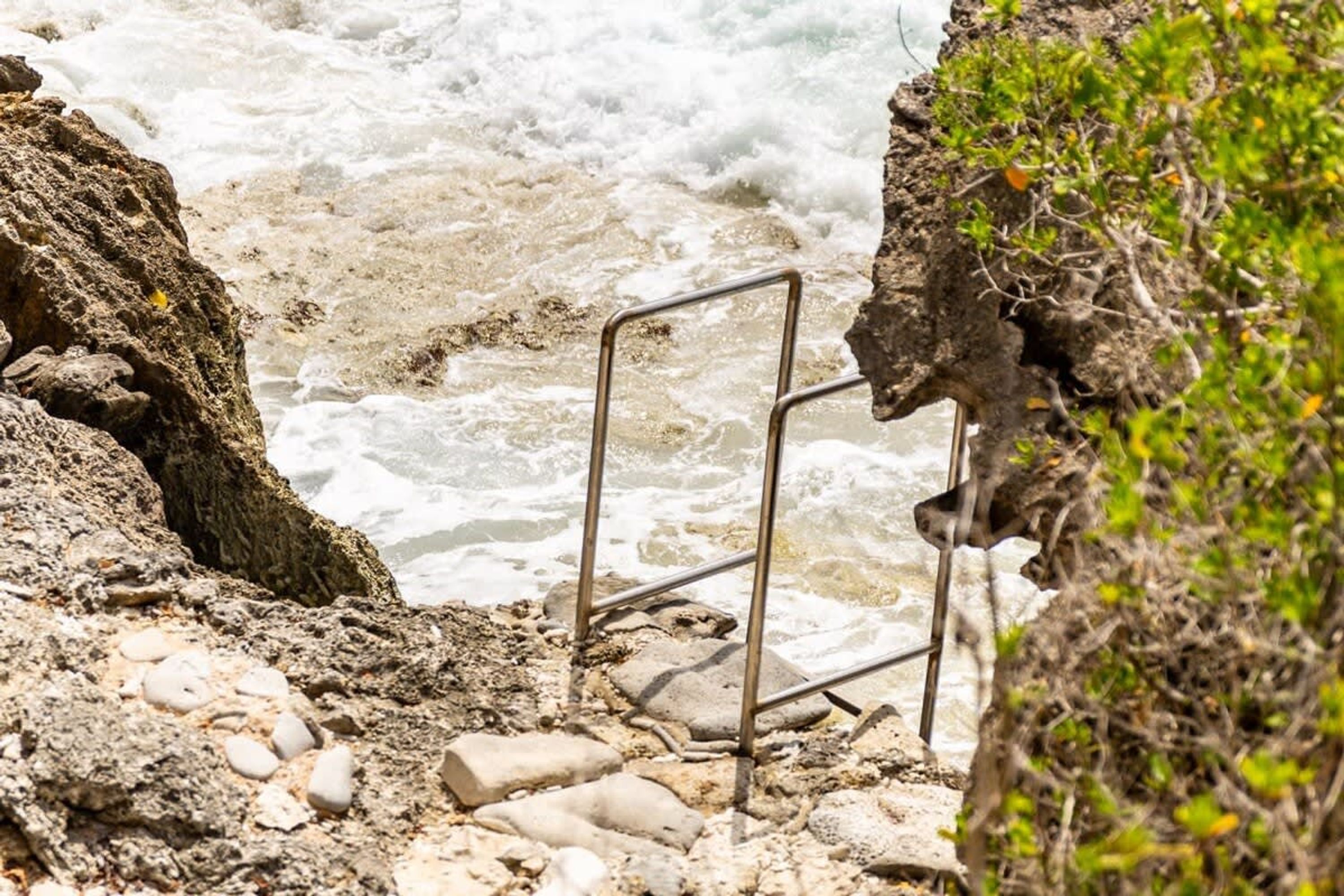A rocky shoreline with waves crashing against the rocks.