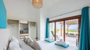 A bedroom with a bed, a wardrobe, and a view of an outdoor patio with chairs and a pergola. - Gosa Di Bida I Private Pool (St. Marie)