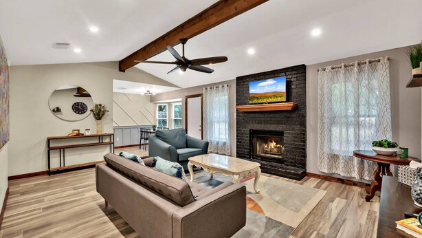 A modern living room with a sofa, coffee table, and fireplace.
