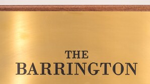 A gold plaque with the inscription "THE BARRINGTON" on a wall. - The Barrington (Durham)