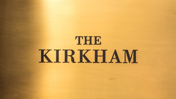 A gold plaque with the text "THE KIRKHAM" on a wall. - The Kirkham (Durham)