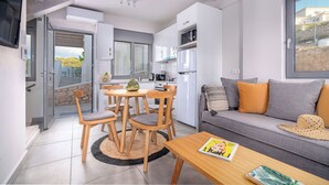 A modern apartment with a dining area, kitchen, and living room. - Aqua Villa II - Entire villa in Elafonisos, Laconia, Greece (Peloponnese)