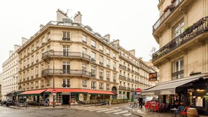 A multi-story building with a cafe named "Mamacita" on the ground floor, a restaurant "Bistro de la Banque" on the second floor, and a bar on the third floor.