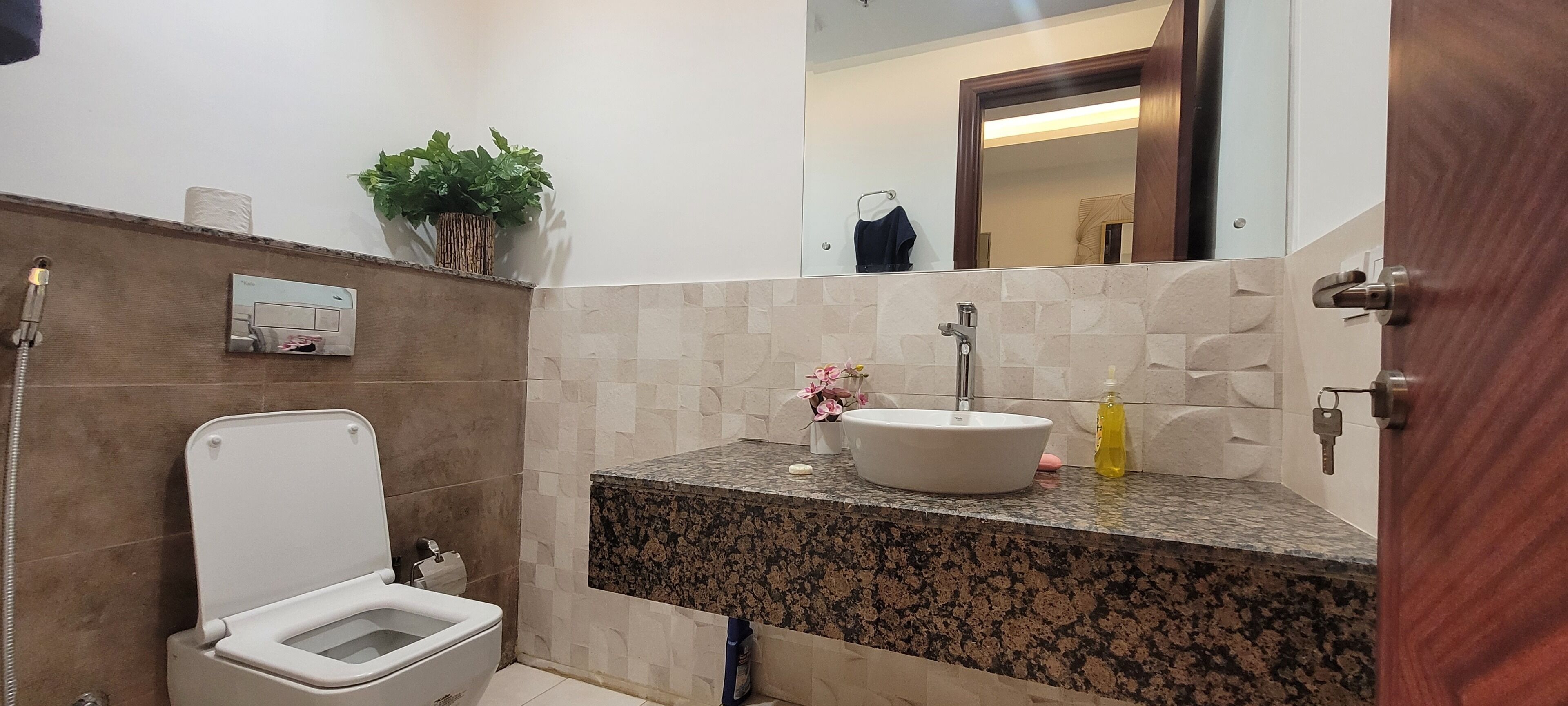 A bathroom with a toilet, sink, and shower.