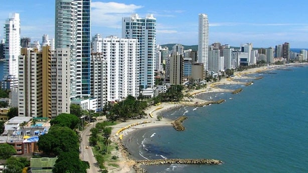 A coastal cityscape with high-rise buildings, a sandy beach, and a clear blue sky. - w Fantastic 2BR Apartment w AC in Cartagena (Cartagena)
