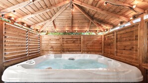 A wooden cabin with a hot tub.
