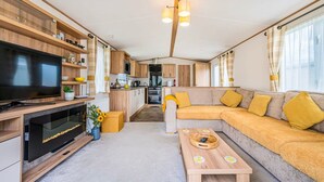 A modern RV interior with a living area, kitchen, and entertainment space. - Your Ultimate Holiday Rental at Pevensey Bay (Pevensey)