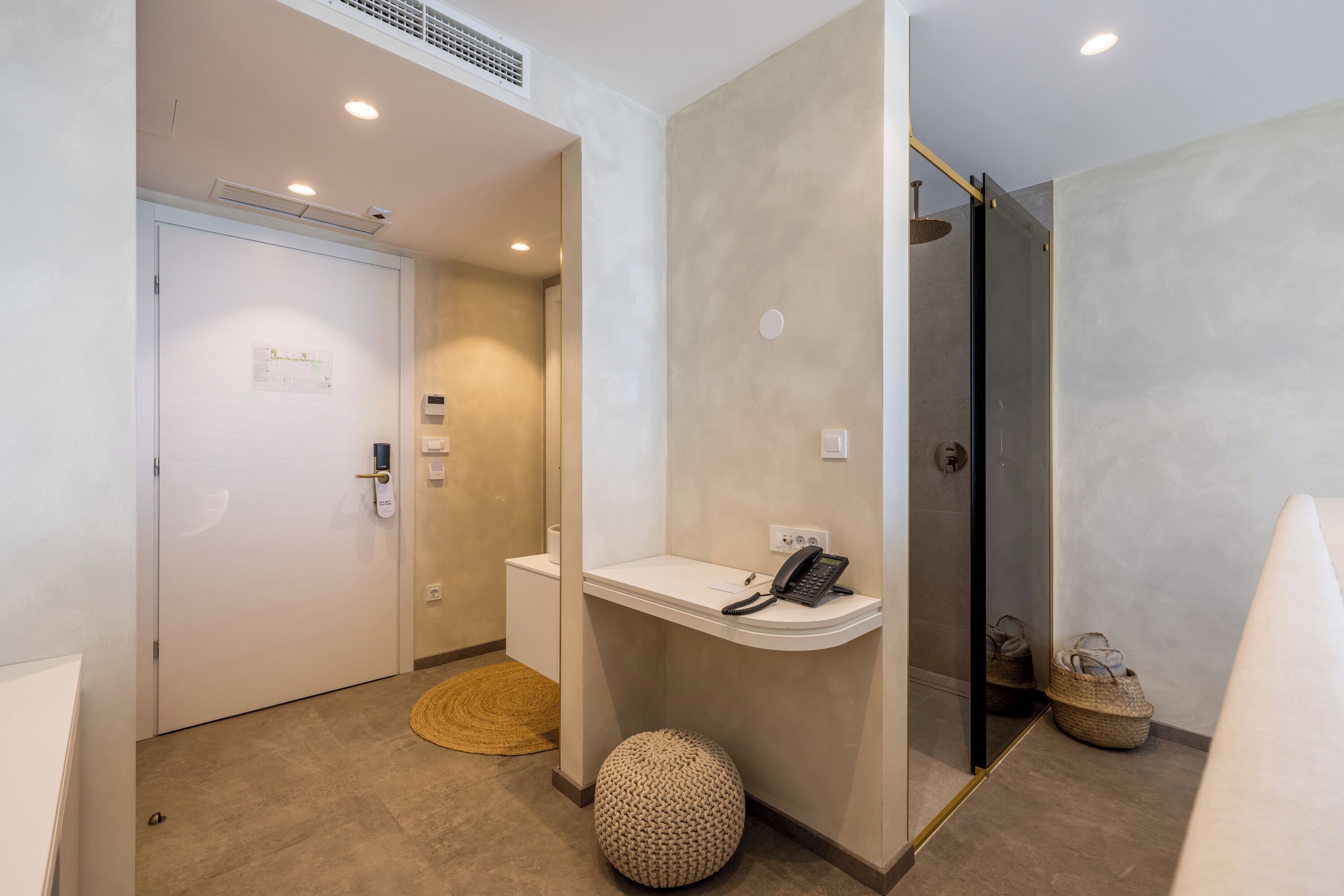 A modern bathroom with a toilet, sink, and shower.
