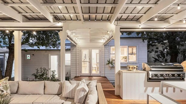 A spacious outdoor living area with a sofa, a grill, and a dining table. - Oliver s Cottage Yarra Valley Spa and Sauna (Yarra Glen)