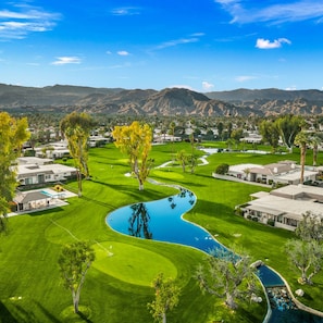 Enjoy a scenic round of golf surrounded by lush greenery and mountain views.