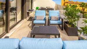 An outdoor patio with a seating area, including a table and chairs, and a potted plant. - Mediterranean Views by Bookaparadise (Finestrat)