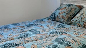 A bedroom with a bed, a window, and a wall-mounted artwork. - Polop Hills 21A by Bookaparadise (Polop)