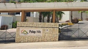 A sign for Polop Hills with a mountainous backdrop. - Polop Hills 21A by Bookaparadise (Polop)
