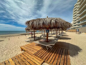 A beachside hotel deck with lounge chairs, a thatched umbrella, and a wheelchair-accessible sign. - 3BR Gem at Sandy Beach Area (Puerto Peñasco)