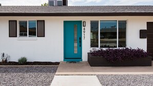 A modern house with a teal door, numbered 4917, and a small garden area. - Family Retreat By Old Town w Pool (Phoenix)