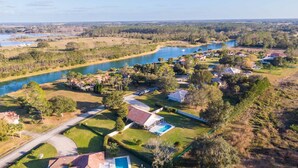 A residential area with houses, a swimming pool, and a river. - Swiss 49 - Lake Denise (Clermont)