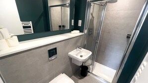 A modern bathroom with a shower, toilet, and sink. - Manchester Industrial by Casacity (Manchester)