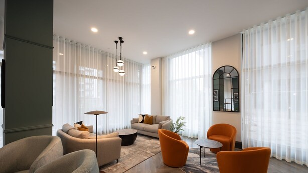 A modern living room with a sofa, armchairs, and a coffee table. - Organika Suite by Casacity (Salford)