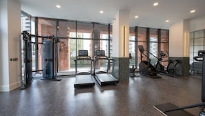 A modern gym with treadmills, elliptical machines, and weight equipment. - Organika Suite by Casacity (Salford)