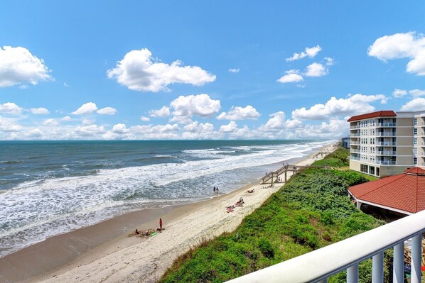 A beachside hotel with a view of the ocean, a sandy beach, and a staircase leading to the beach. - Point unit with Spectacular Views (North Topsail Beach)