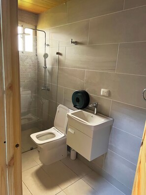 A bathroom with a toilet, a sink, and a shower. - Elegant - Luxury and Private Villa (San Antonio de Guerra)