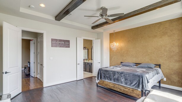 A bedroom with a bed, a ceiling fan, and a chandelier. - Houston Home w/ Rooftop Patio - 3 Mi to Downtown! (Houston)