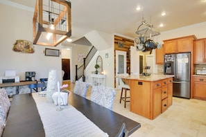 A spacious kitchen with wooden cabinets, a central island, and a stainless steel refrigerator. - Hot Tub, Heated Pool, Fire Pit: 6 Mi to Campus (Eugene)