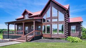 A log cabin with a large deck, multiple windows, and a red roof. - Scenic Getaway w/ Deck: 7 Mi to Mammoth Cave Park! (Brownsville)