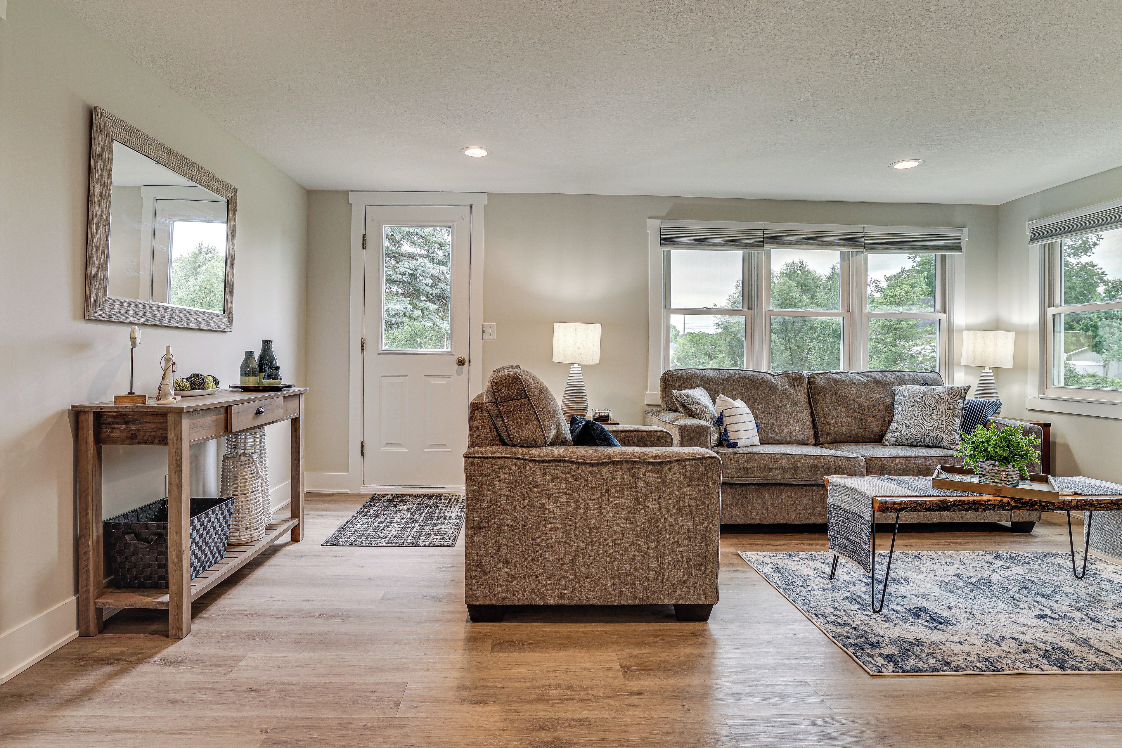 A living room with a sofa, a coffee table, and a console table with storage.